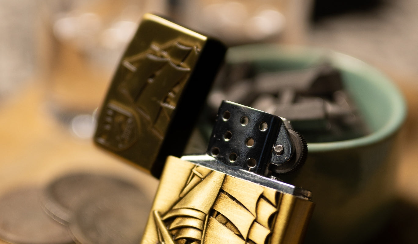 A Zippo lighter leaning on an ashtray