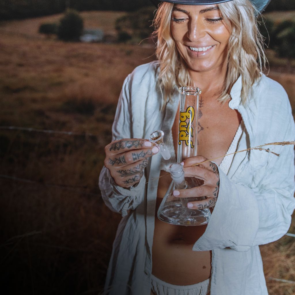 Woman holding a glass Bud Beaker Bong