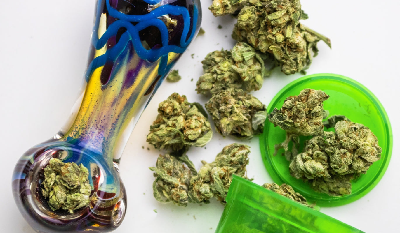 Glass pipe with cannabis buds