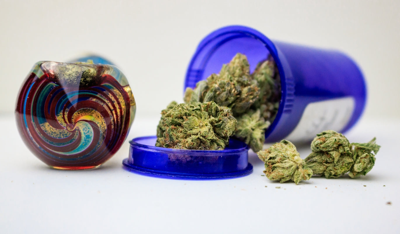 A glass pipe next to medical marijuana