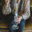 Woman holding a glass gripper bong