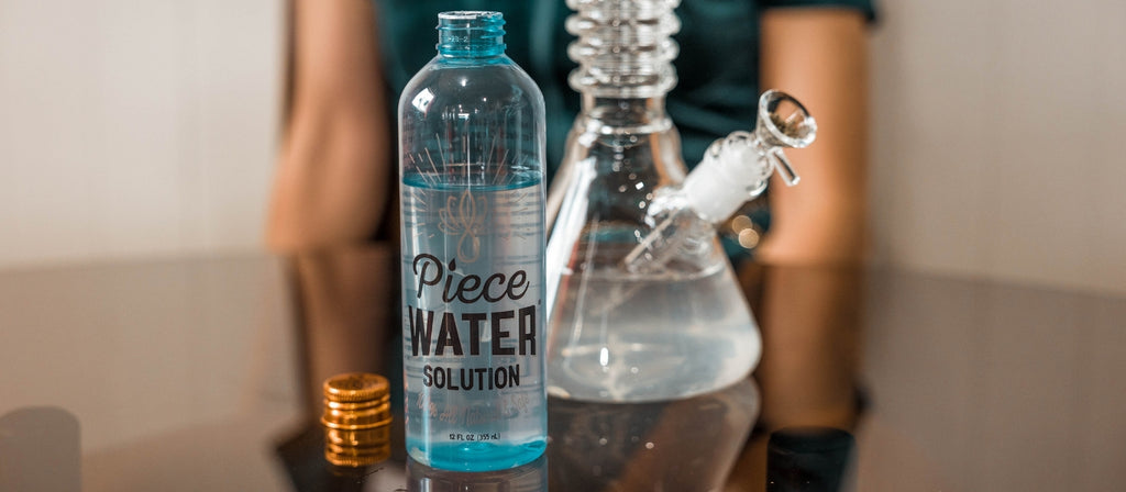 Bottle of Piece Water Solution and bong