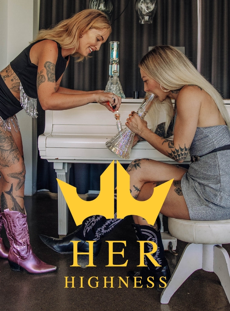 Two women smoking from a Her Highness glass bong