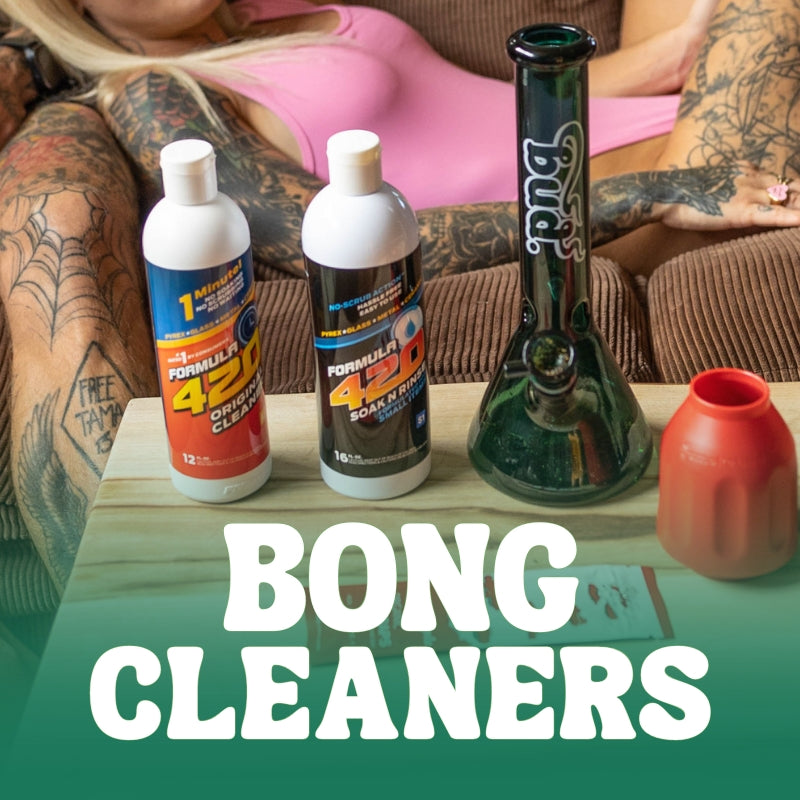 Two bottles of bong cleaner next to a bong