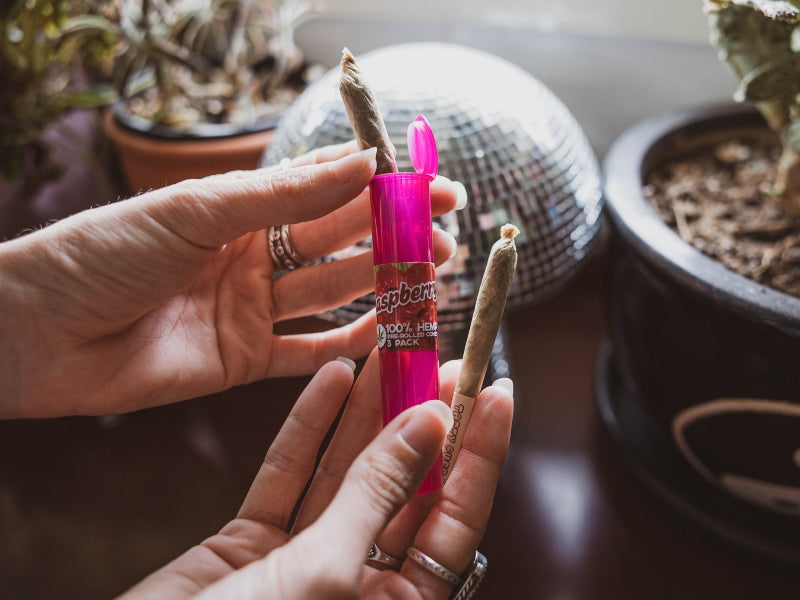 Woman holding two pre-rolled joints