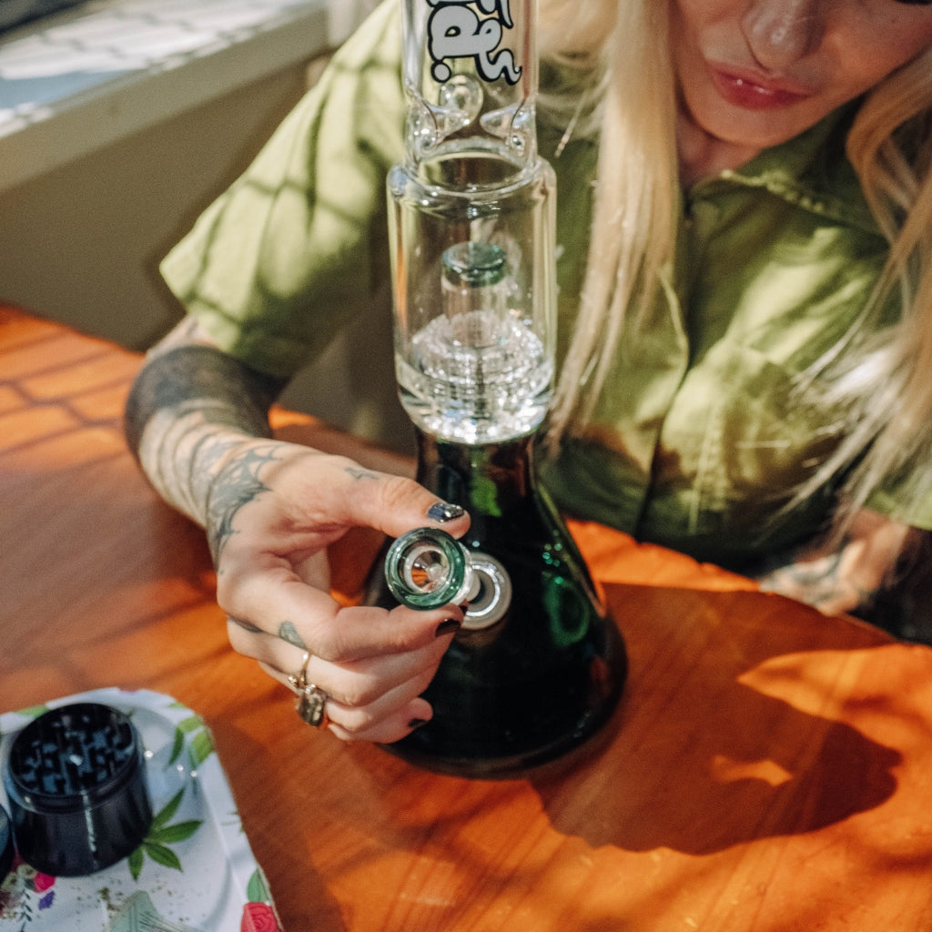 Woman inserting cone piece into Bud Matrix Percolator Bong 40cm - Teal