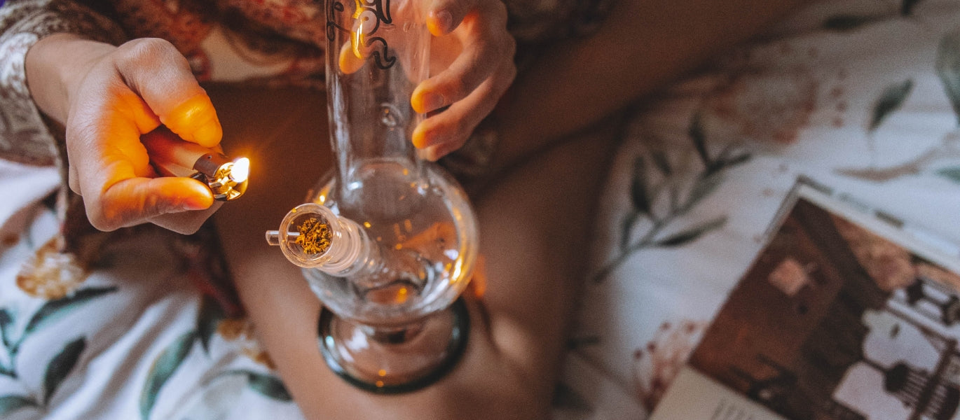 Woman lighting packed glass cone piece