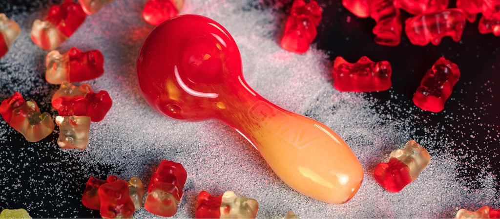 A GRAV glass spoon pipe surrounded by gummy bears