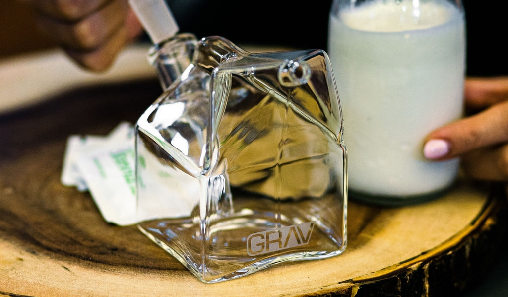 A GRAV milk carton bong next to a bottle of milk