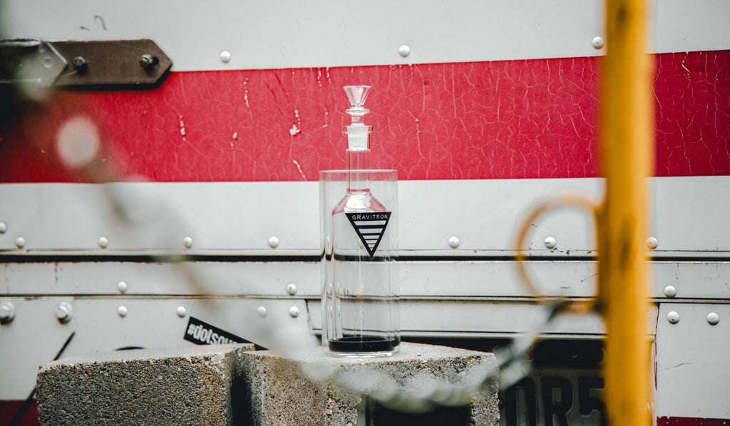 A glass gravity bong on a concrete block