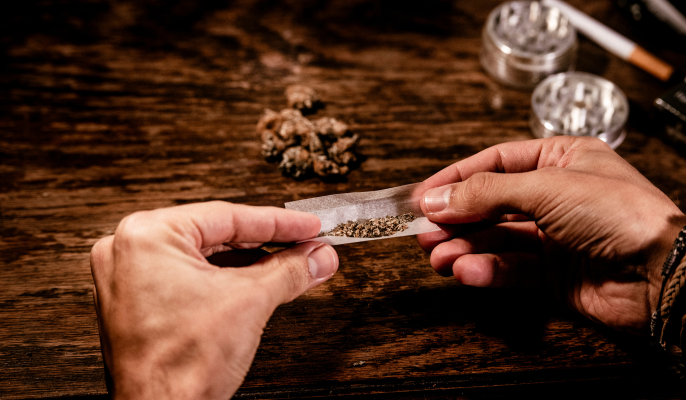 A person rolling a joint with two hands