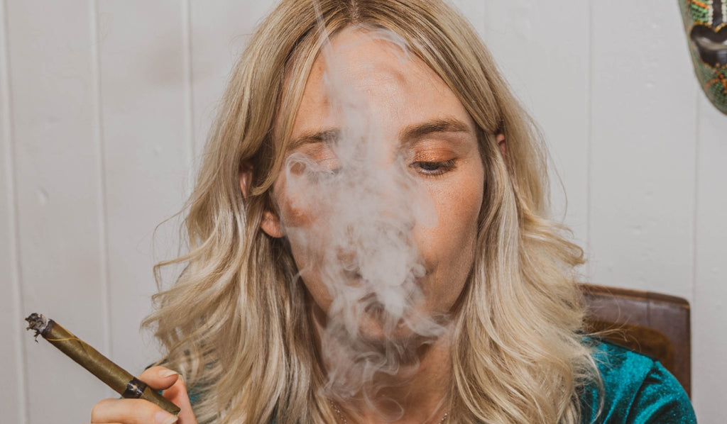 A woman exhaling cannabis smoke