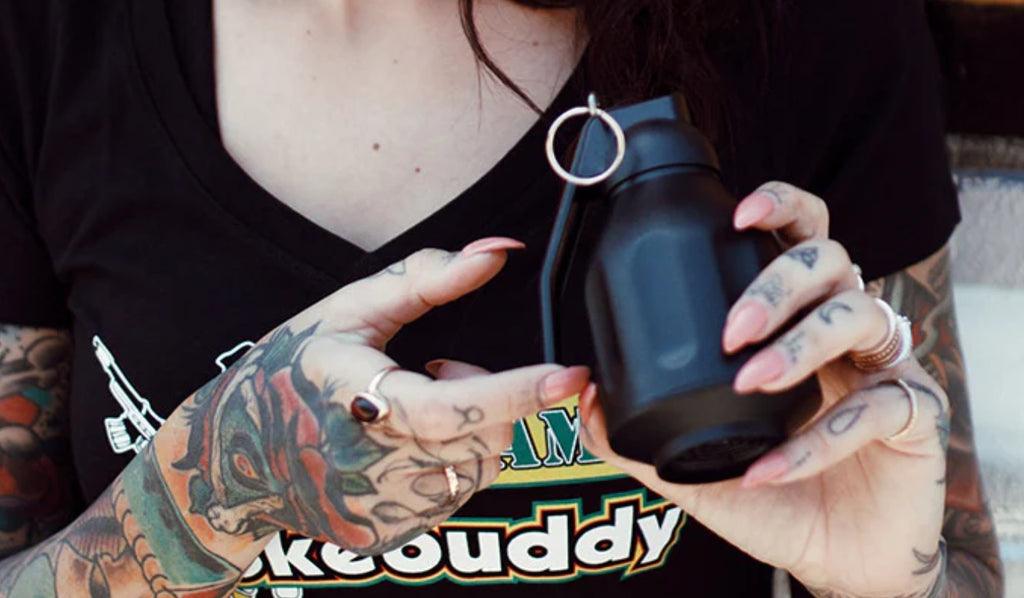 A woman holding a black Smoke Buddy Personal Air Filter