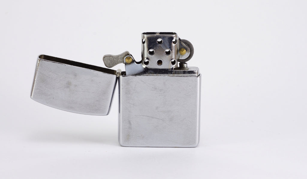 An open Zippo lighter on a white background