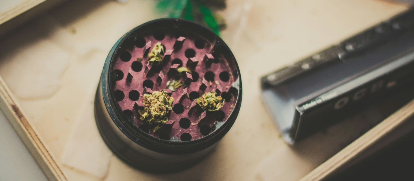 An open black weed grinder