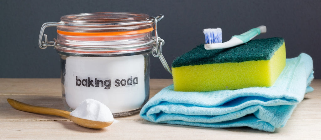 Jar of baking soda next to cleaning supplies