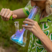 Woman smoking glass beaker bong