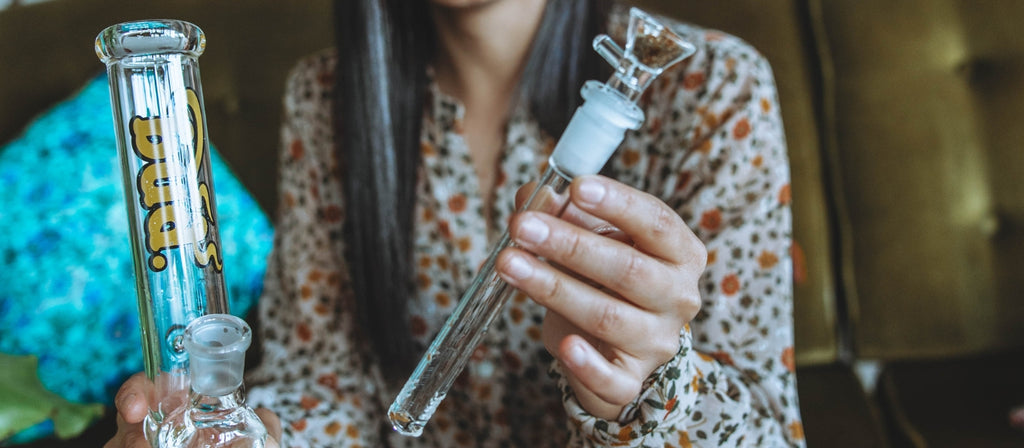 Woman holding a diffusor downstem and Bud Gripper Bong