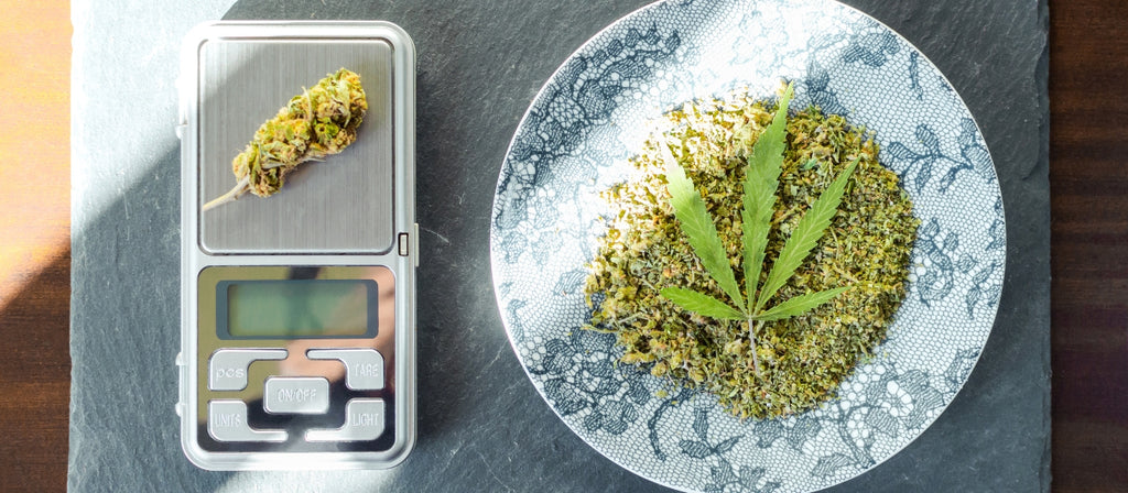 Digital scale and a plate of ground cannabis