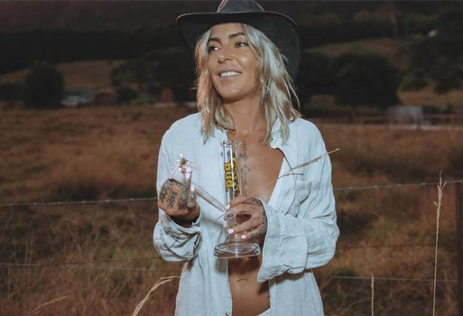 Woman holding a Bud Beaker Bong 25cm