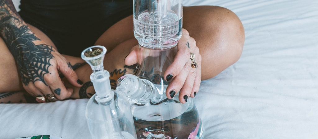 Glass bong with water in chamber and percolator