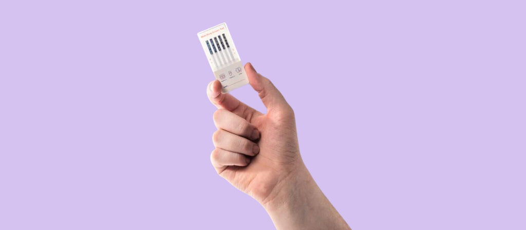 Hand holding an at-home uTest drug test