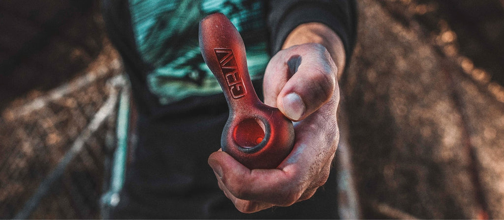 Hand holding a GRAV glass spoon pipe
