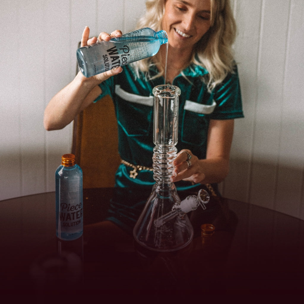 Woman pouring water into a glass bong