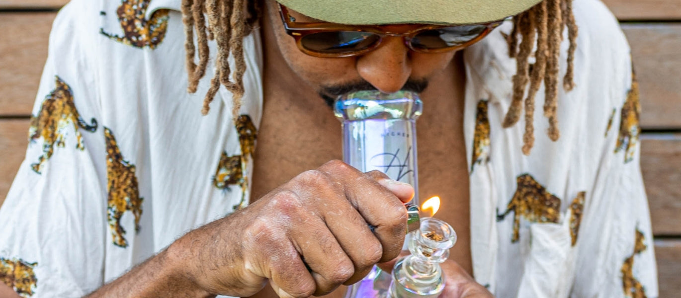 Man lighting glass bong