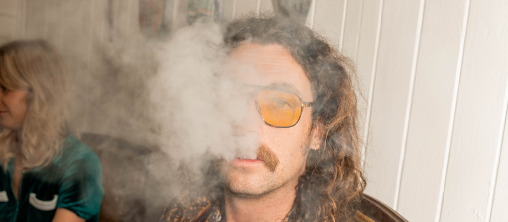 Man exhaling cannabis smoke
