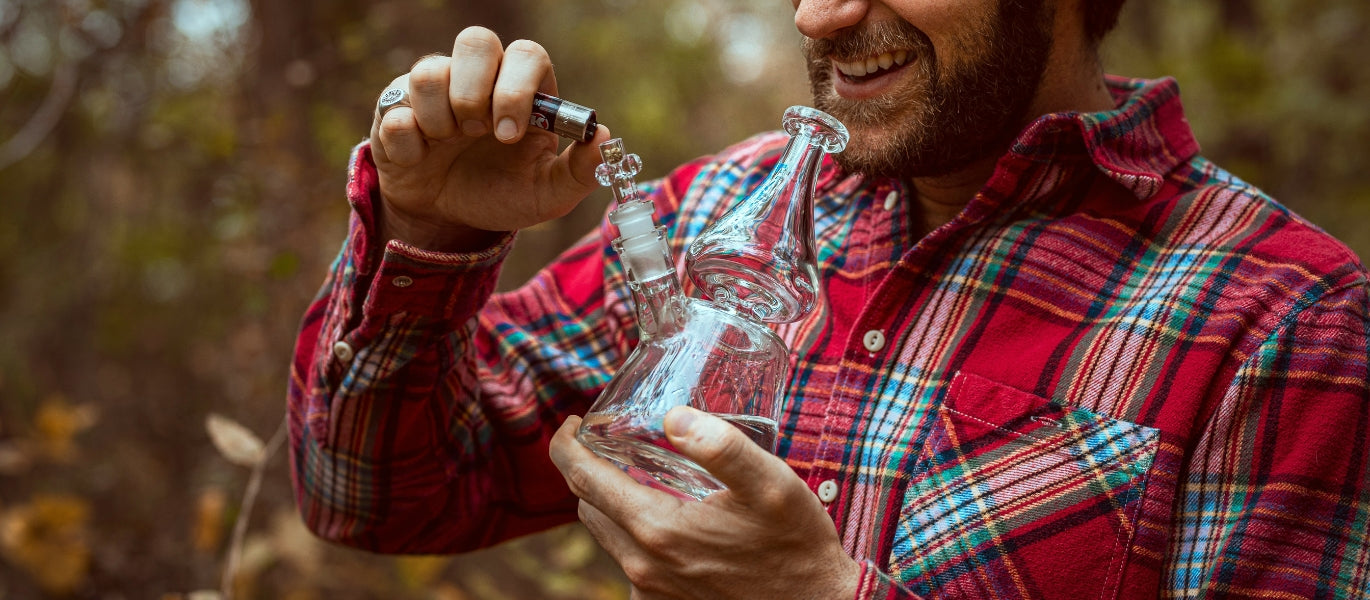 Man lighting a glass bong