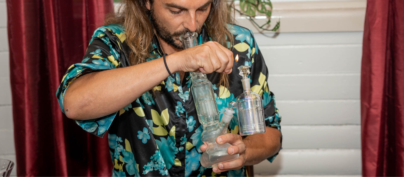 Man lighting bong with percolator ash catcher