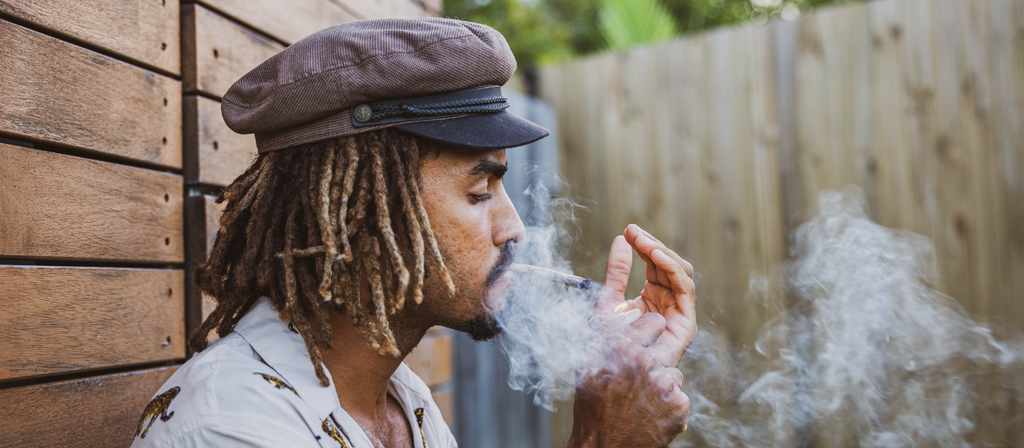 Man smoking cannabis and exhaling