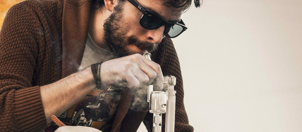 Man smoking from an inline percolator bong