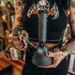 Person holding a black glass bong