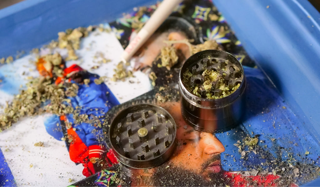 Open weed grinder on rolling tray