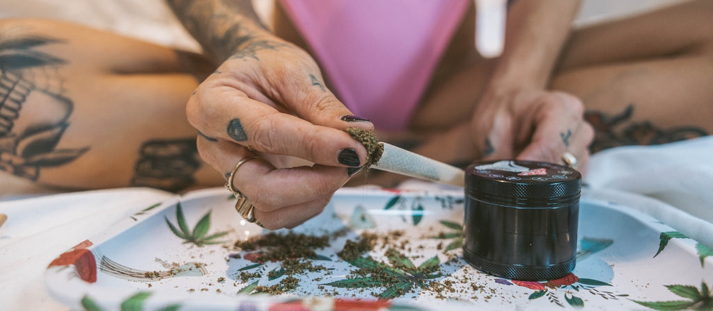 Woman packing a pre-rolled cone with cannabis