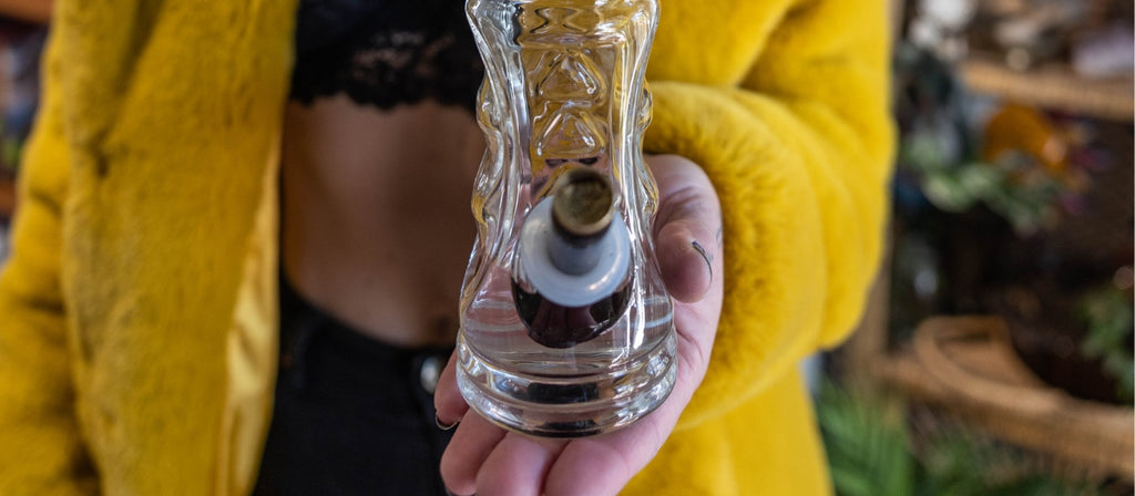 Person presenting a glass bong