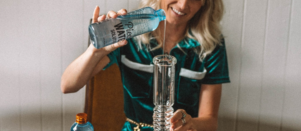 Woman pours Piece Water Solution into a beaker bong