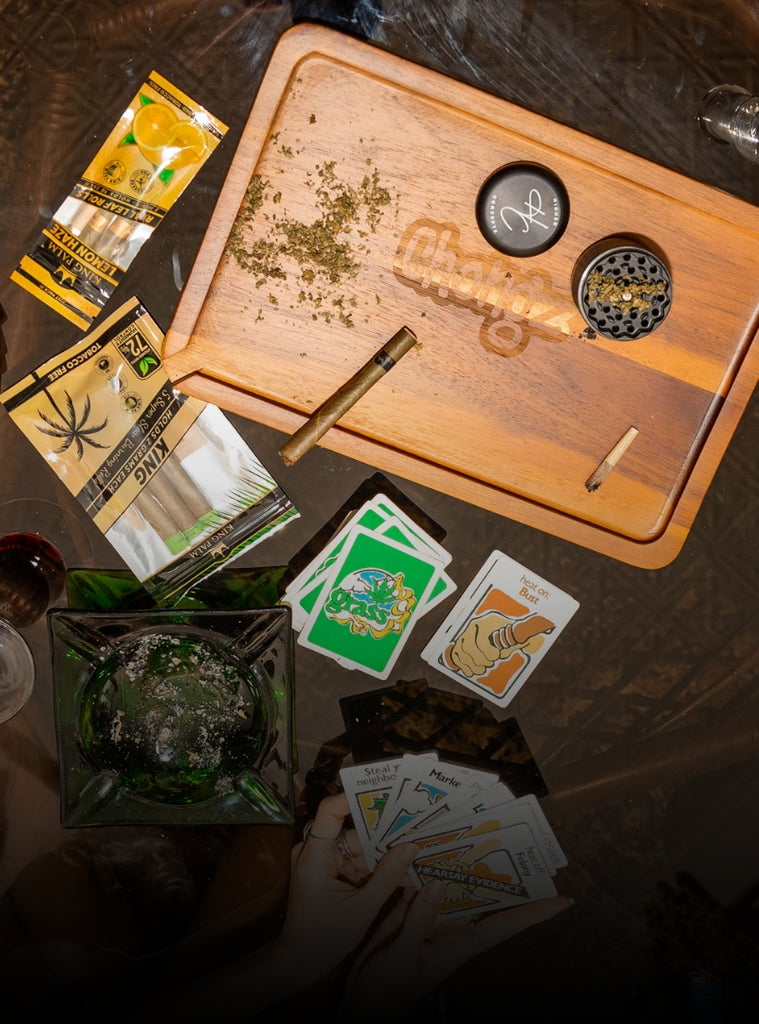 Table covered in smoking accessories and cannabis