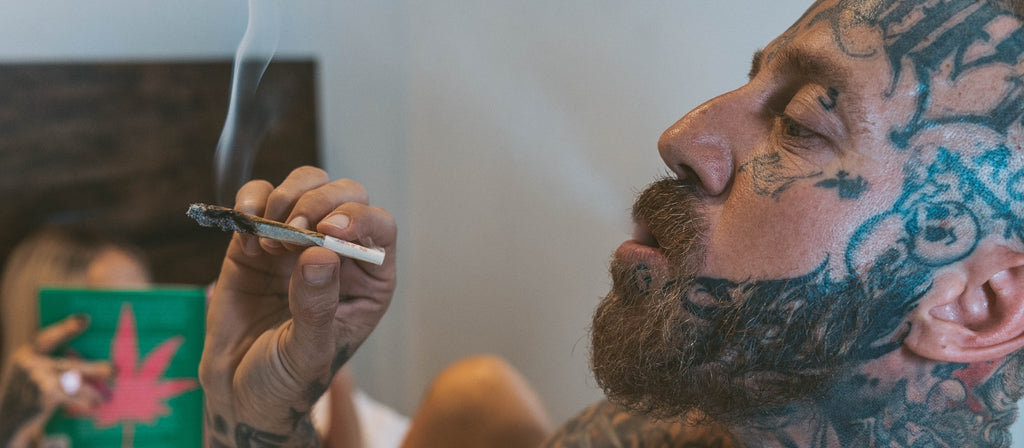 Man smoking a pre-rolled cone