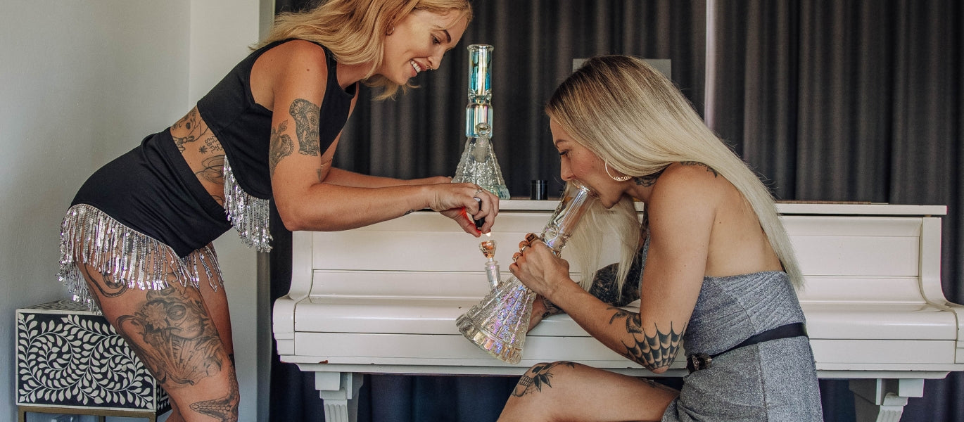 Two women lighting Her Highness Bong