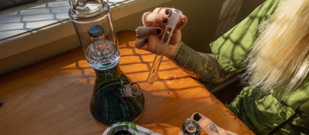 Woman holding a glass diffusor downstem alongside Bud Matrix Percolator Bong