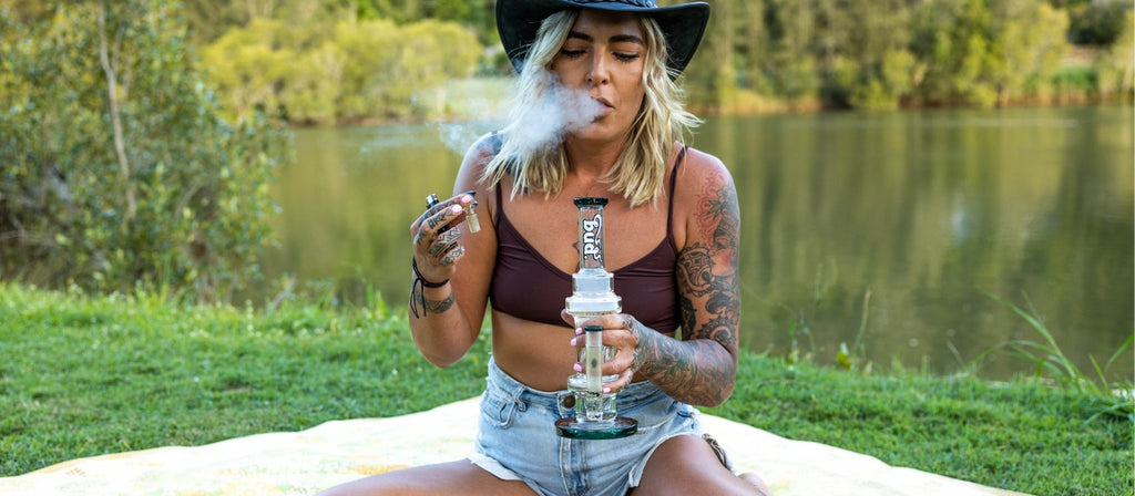 Woman smoking from a Bud Inline Percolator Bong