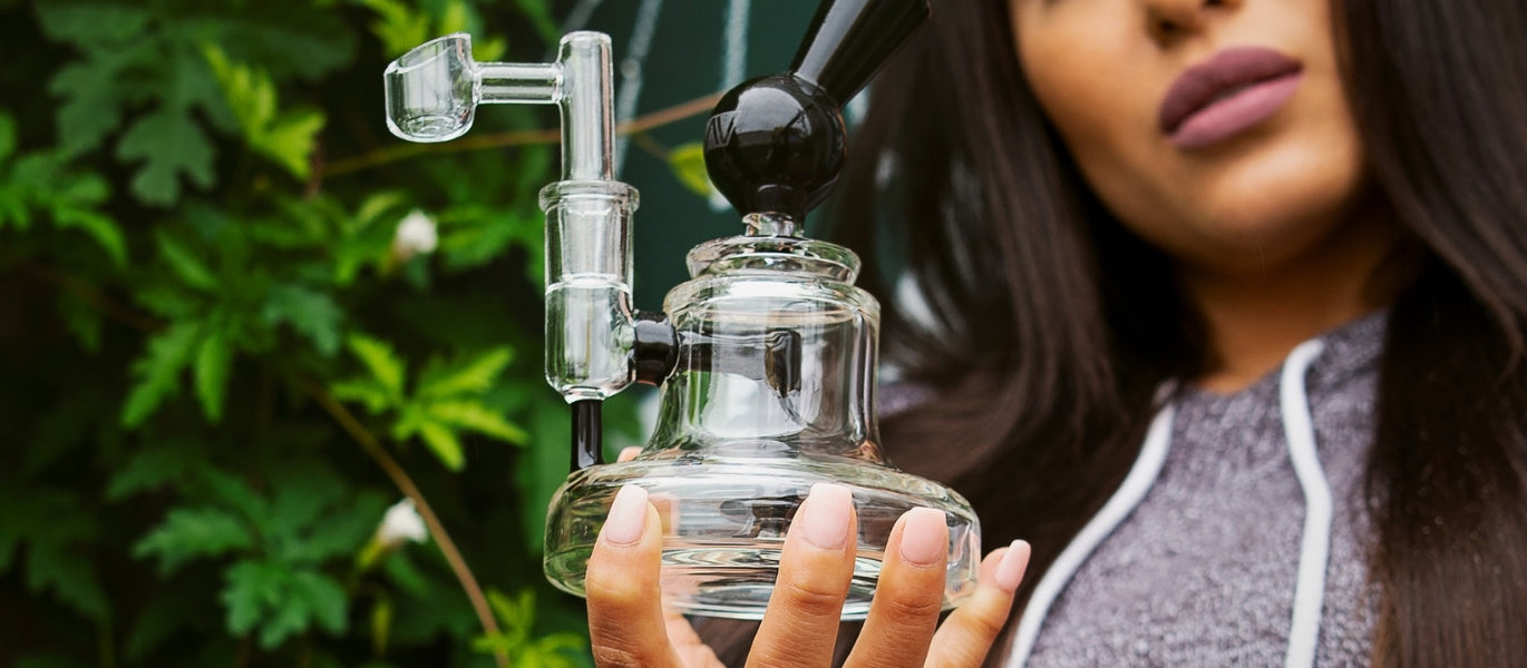 Woman holding GRAV Orbis Lume Dab Rig