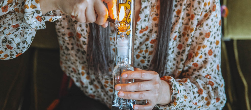 Woman lighting glass gripper bong