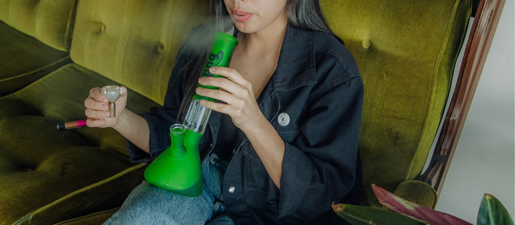 Woman smoking green glass tree percolator bong