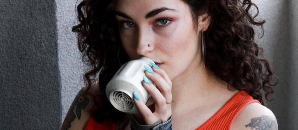 Woman using a Smokebuddy Original Personal Air Filter
